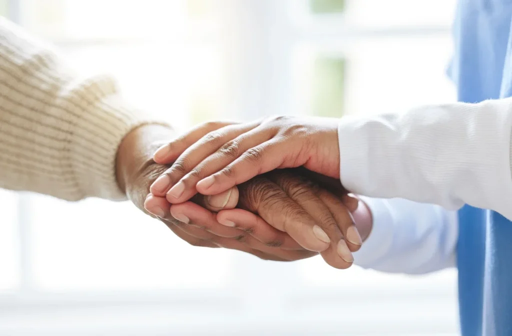 Close up of 2 sets of hands holding